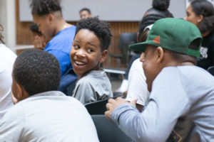 Students laughing during the rap battle competition.
