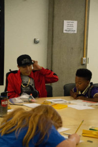 Students learning to write rap lyrics.
